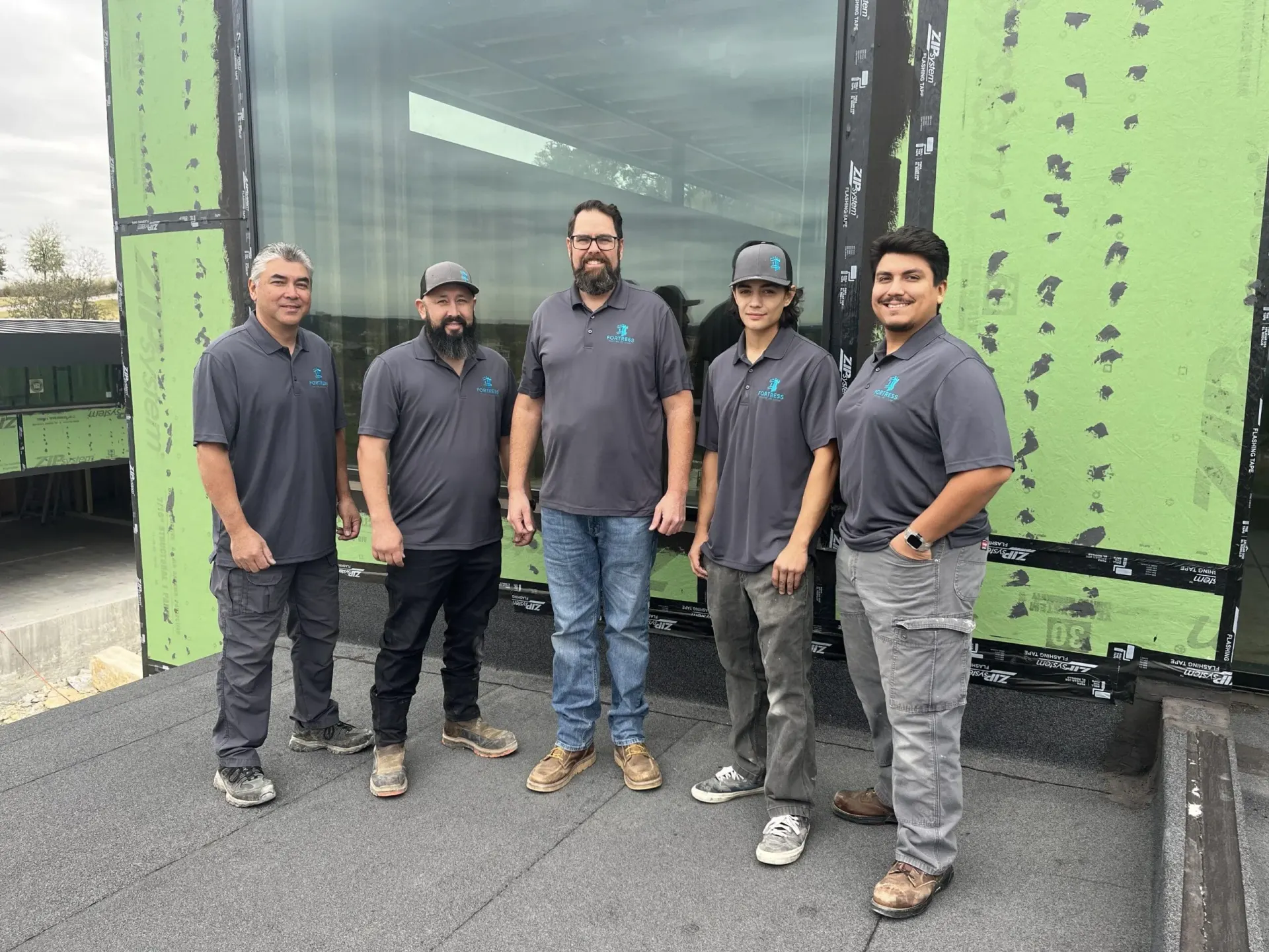 Fortress installation team outside a building under construction