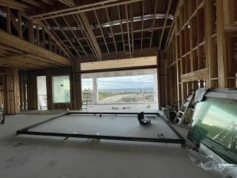 Door frame and glass panels inside an unfinished double-height room