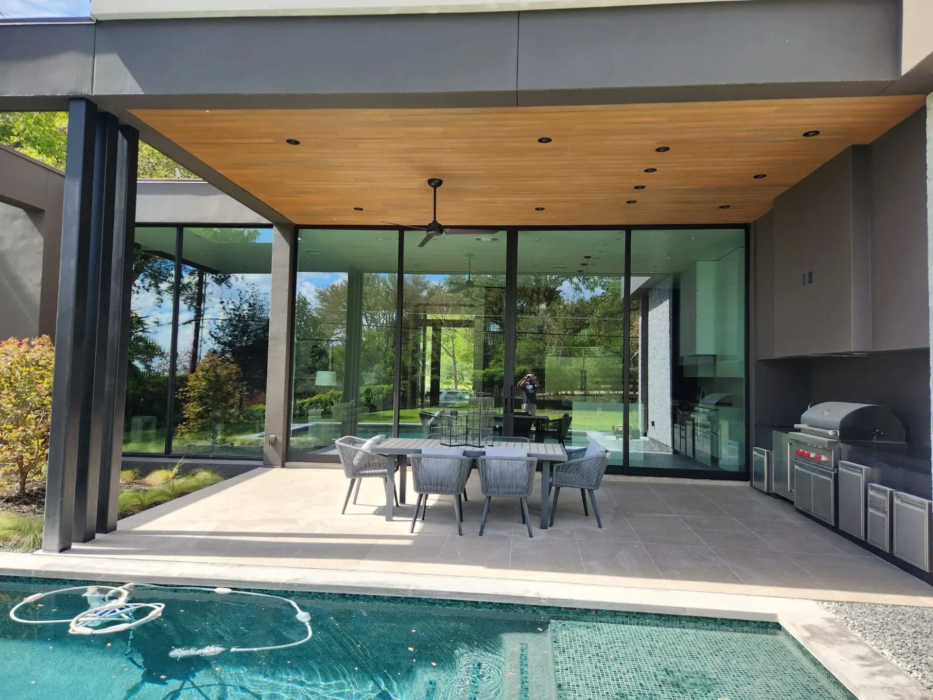 Poolside dining patio surrounded by large glass doors